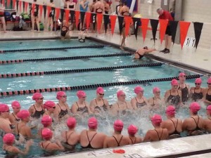 The WSH swim team warms up with Cotter students.