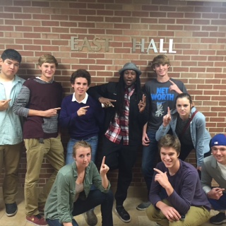 (from left): JJ Corn, Logan De Vorak, Ryan Ortega, Kirsten Weifenbach, Hunter Andre, Gabby Bowlin, Jake Cake Renk, and Mac R. Whaley join hip-hop artist Toki Wright (center) at Winona State University