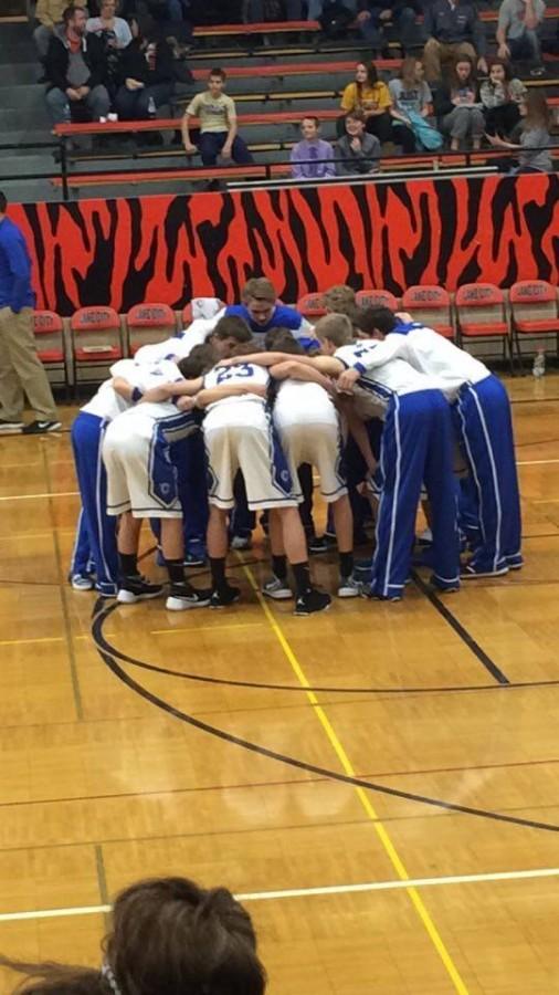 The Cotter boys basketball team huddles before their season opener against Lake City. The Ramblers lost 58-47