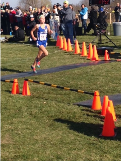 Cotter 7th grader Grace Ping crosses the finish line at the 2015 state cross country meet in Northfield, Minn.