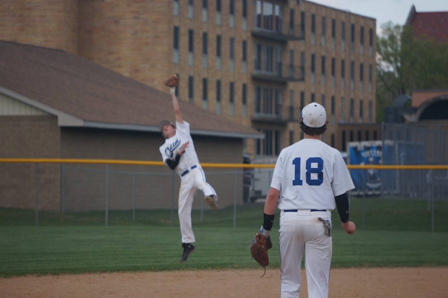 Logan DeVorak leaps to snag at a liner at short