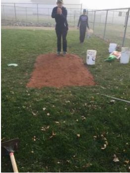 Eagle Scout puts in new bullpen mound.