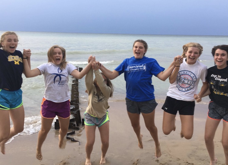 Cotter students relaxing on the shore of Lake Michigan during Benton Harbor CCMP trip