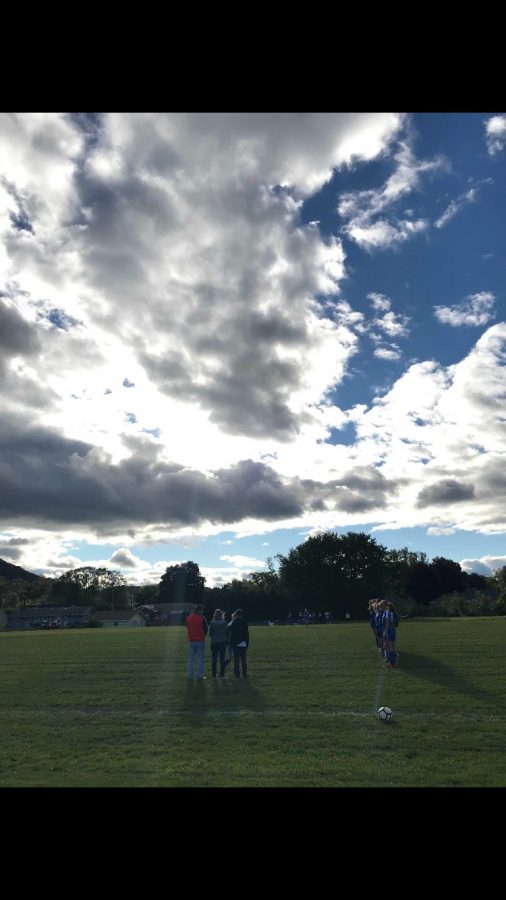 Soccer team presents flowers to family during halftime