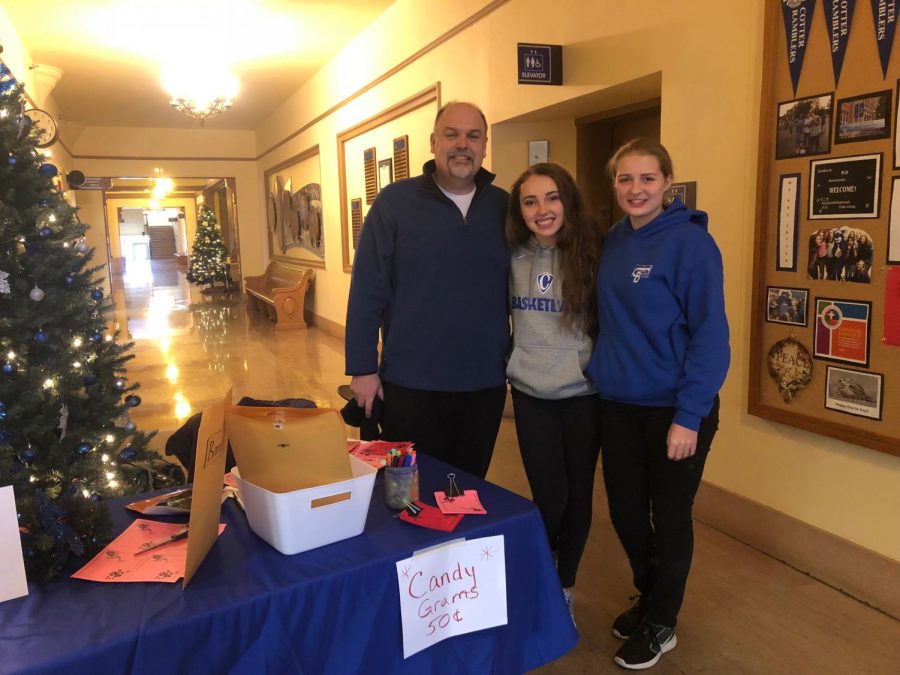 Mr. McGlaun poses with Mary Morgan and Rita Row after purchasing candy grams from them.  Photo Madelyn Arnold