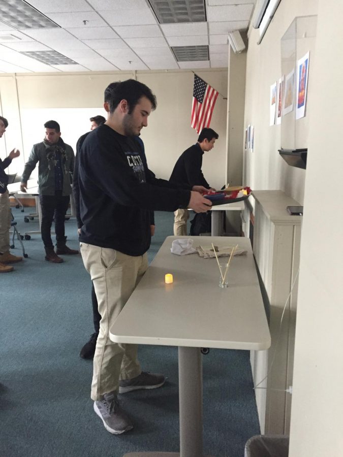Dylan Bannon makes an offering to a deity to learn practices of Hinduism in World Religions class
