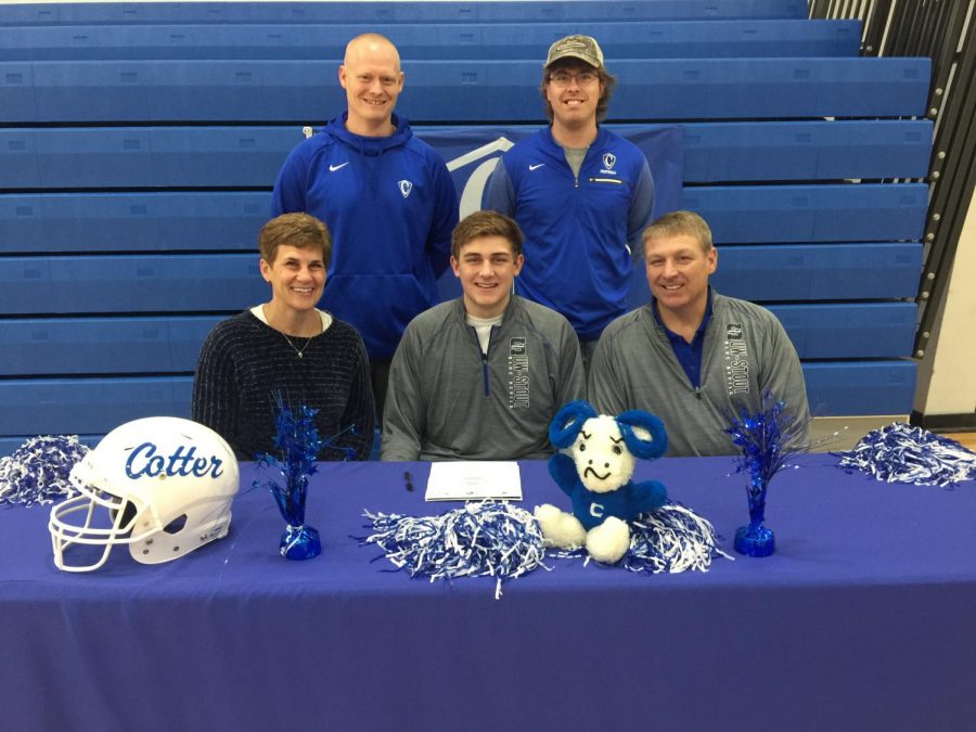 Laken Macal poses with parents and coaches as he commits to play football at UW-Stout