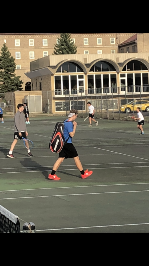 Ian Modjeski takes the court before his match against Lourdes