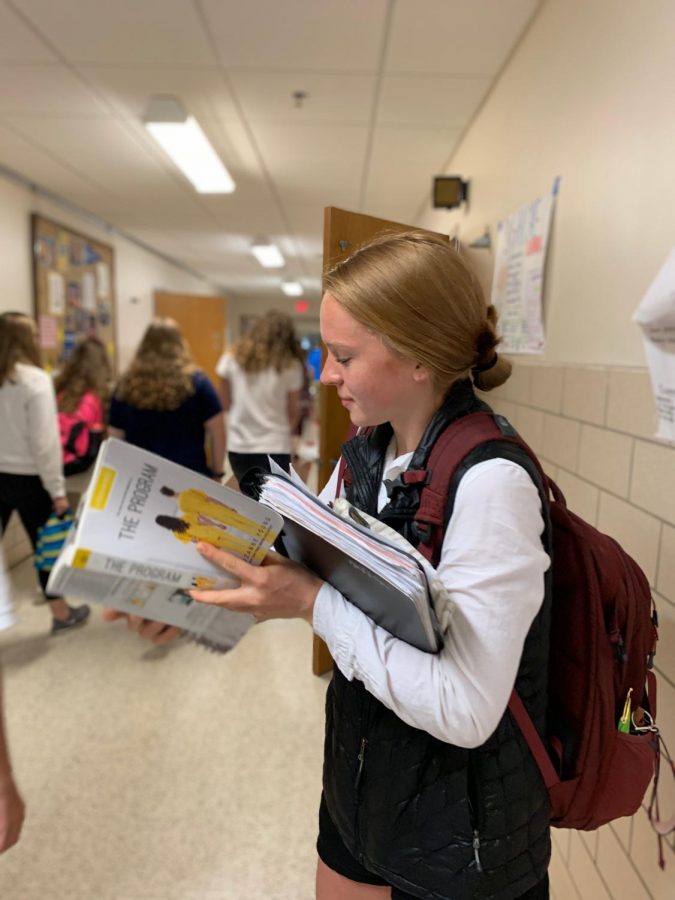 Maren+Stewart+reading+her+lit+circle+book+in+between+classes.++Like+many+students%2C+Stewart+is+juggling+lots+of+activities