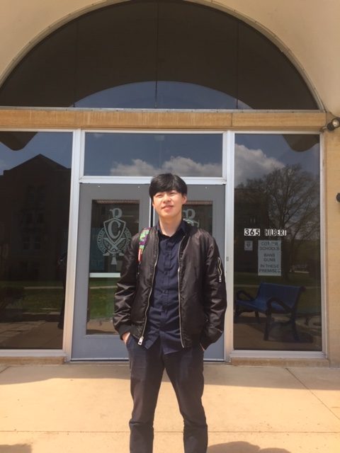 Scott Zhu stands in from of the Loretto Hall dormitory where he spends on time online matching buyers and sellers of custom and rare sneaker