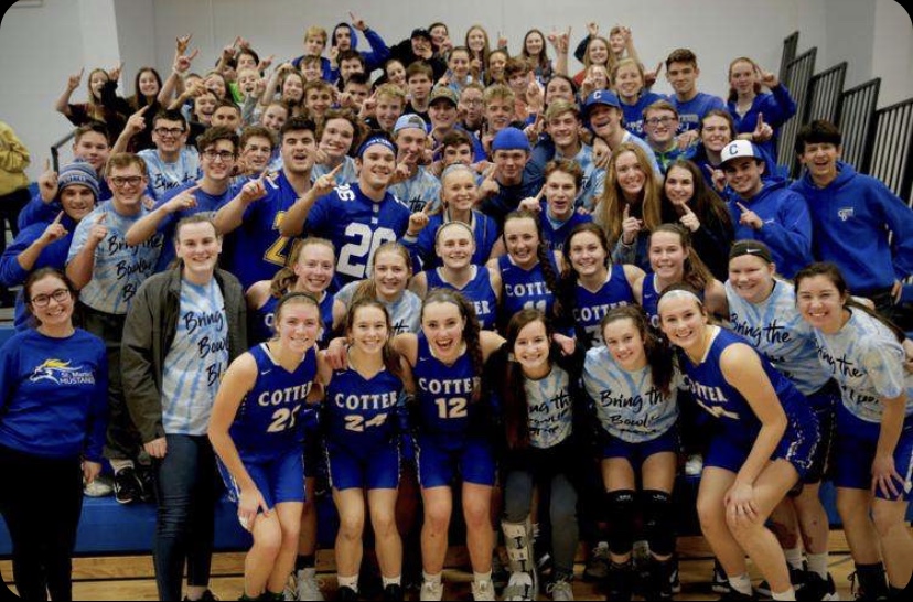 Cotter girls varsity basketball team celebrates with student section after a big win against Stewartville.