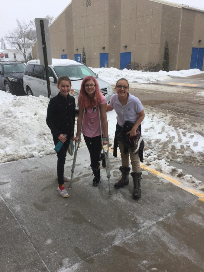 Macy Piechowski, and Ava Koopman help Zayda King-Henke get back to classes after spraining an ankle in PE