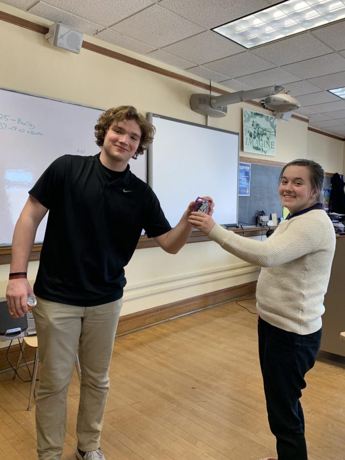 Charlie Reilly delivers a can of Crush to Fiona Flanagan as part of the National Honor Societys fundraiser.