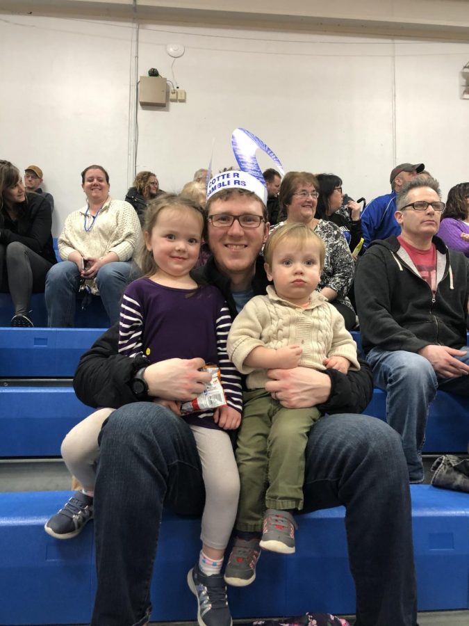 Pictured L to R: Willow Reigstad, Tom Reigstad, and Cedar Reigstad enjoy the Cotter girls basketball game during Catholic Schools Week.