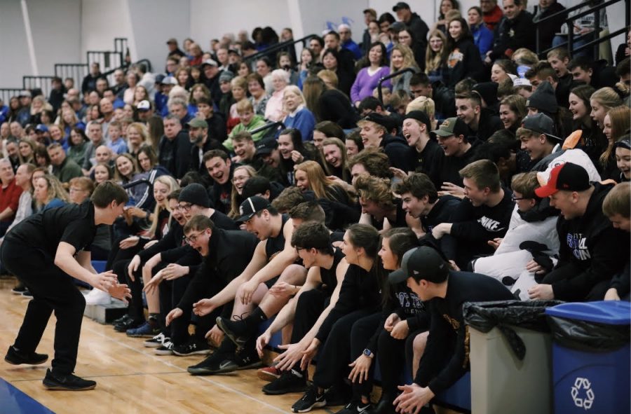8th grader Brett Biesanz leads the student section in "the Rollercoaster"  cheer during a recent girls varsity game 