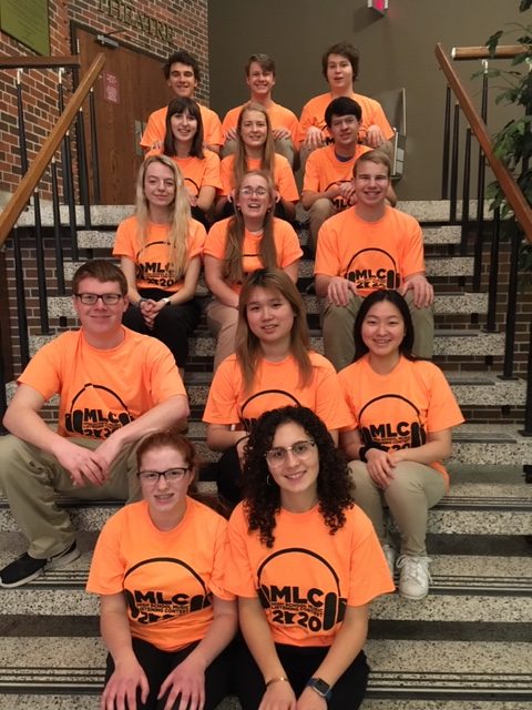 Cotter's music listening team display their team shirts