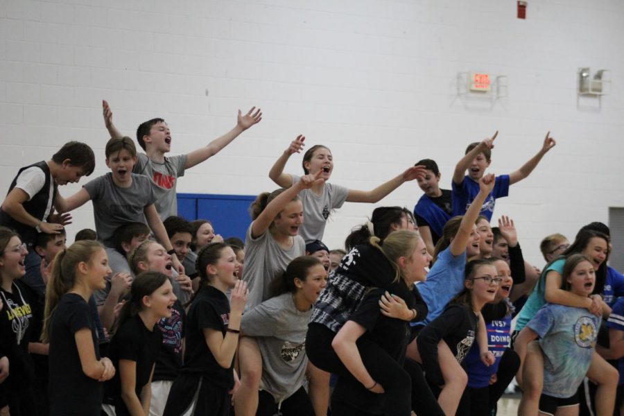 The eighth grade teams gather together to cheer against the seventh graders.