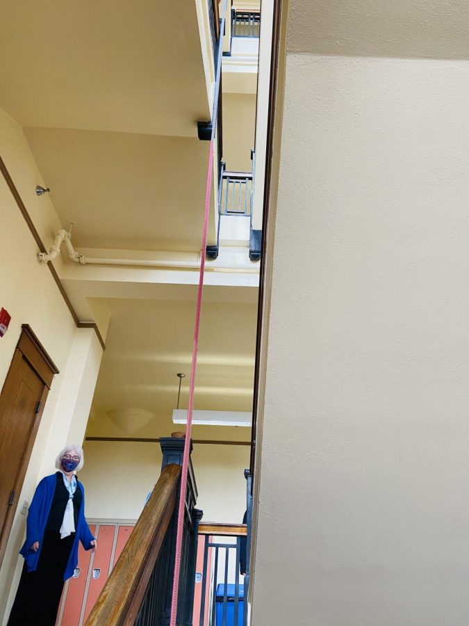 Mary Hansel-Parlin looks on as a parmies project is lowered from the 3rd floor to the first floor lobby