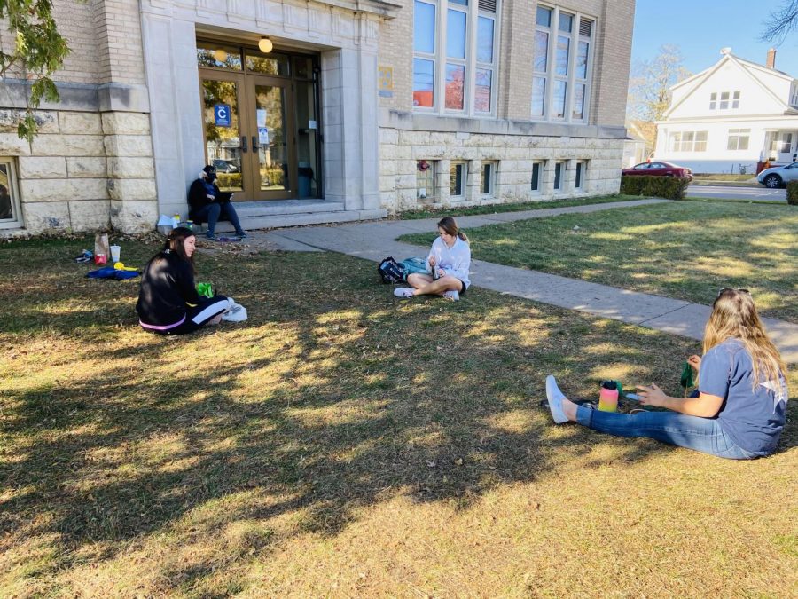 Mary Hansel-Parlin, Ellie Glodowski, Grace Menke, and Alison French meet outside of the Cummings St. entrance to enjoy the weather, knit, and talk.