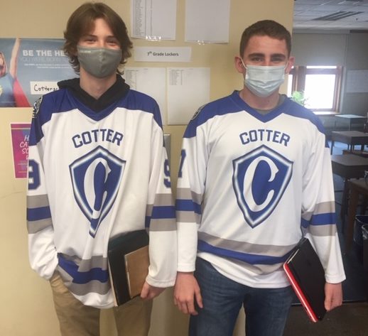 Noah Lange and Ashur Rouleau in their Cotter hockey jerseys