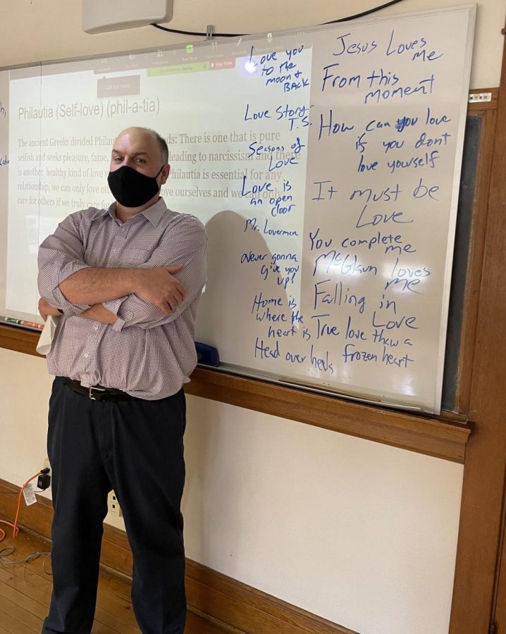 Mr. McGlaun beside a whiteboard filled with cliched sayings about love from pop songs and pop culture