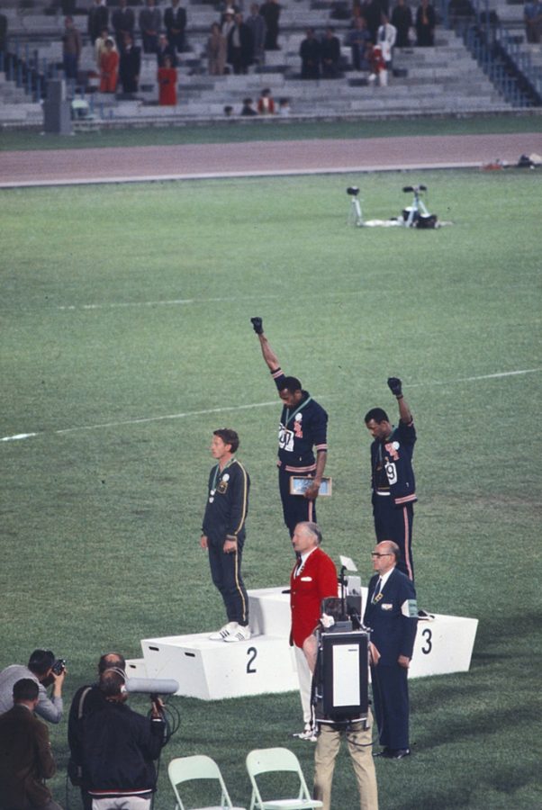 Tommie Smith and John Carlos protesting poverty and racial injustice at the 1968 Olympic Games. Photo via Wikimedia Commons under Creative Commons license