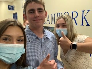 L to r: Mallory Ehlenfeldt, Ashur Rouleau, Olivia Blumers leaving mass on September 2. 