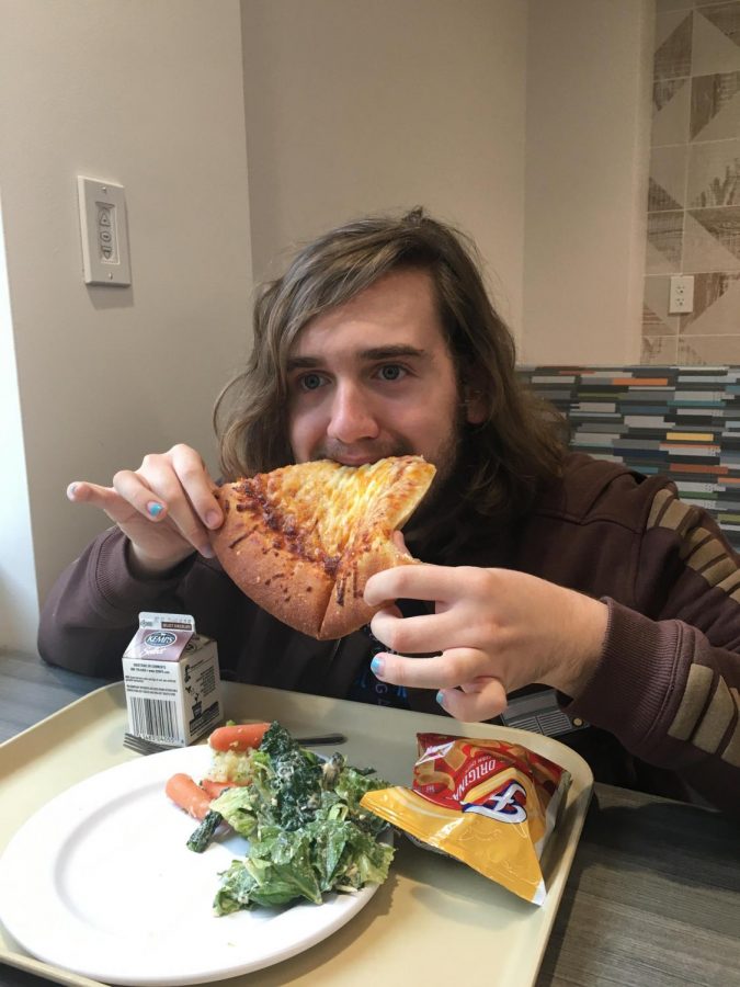 John Littrell eating his "fat and juicy" school lunch of pizza and salad. Photograph by Jonah Heckman.