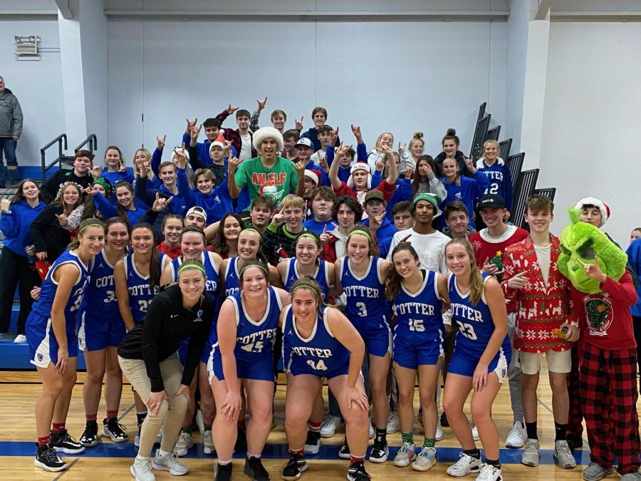 the girls basketabll team poses with the student fan section after their hoome opening victory versus Fillmore Central