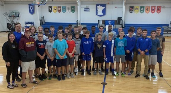 Jonte Flowers and Cotter athletes pose for a photo after Jonte's presentation in the Cotter gym