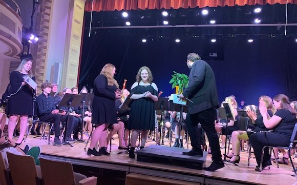 Seniors present Mr. Meurer with gifts during the Spring band concert at St. Cecilia Theater