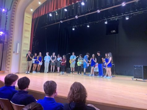 Students receiving awards at the end of the talent show, led by emcee Tomas Castillo