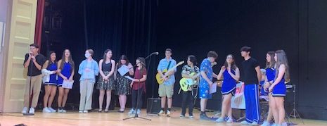 Students receiving awards at the end of the talent show, led by emcee Tomas Castillo