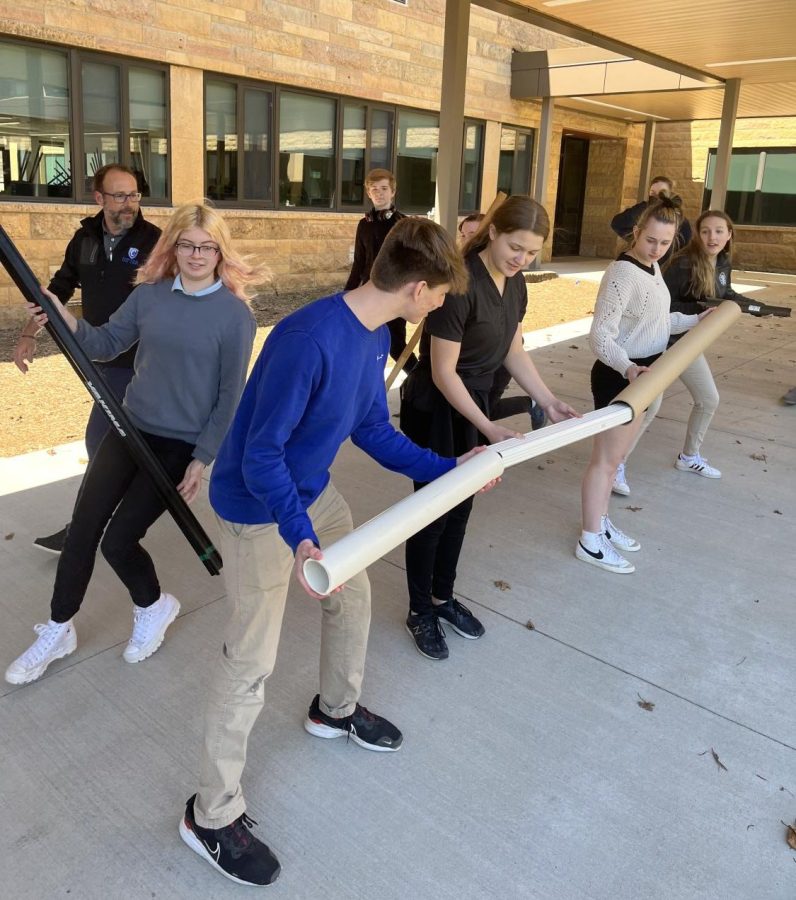 Students test the forces of gravity and momentum in science class 