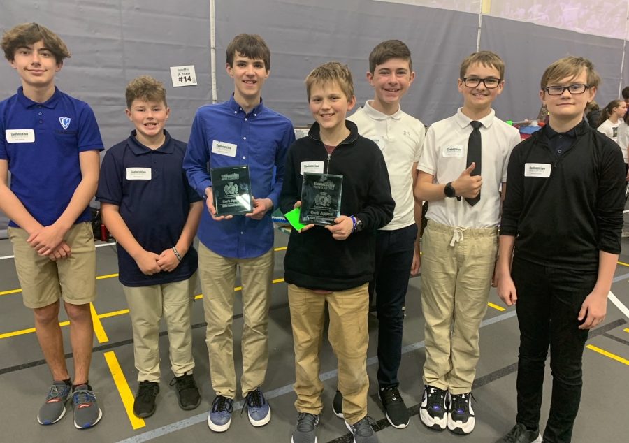 Cotter 7th grade students Jack Slaggie, Will Peterson, Jaxson Greshik, Jacob Moore, Carter Knuesel, Reece Pronschinske, and Zephyr Paulsen display their plaque at the State competition