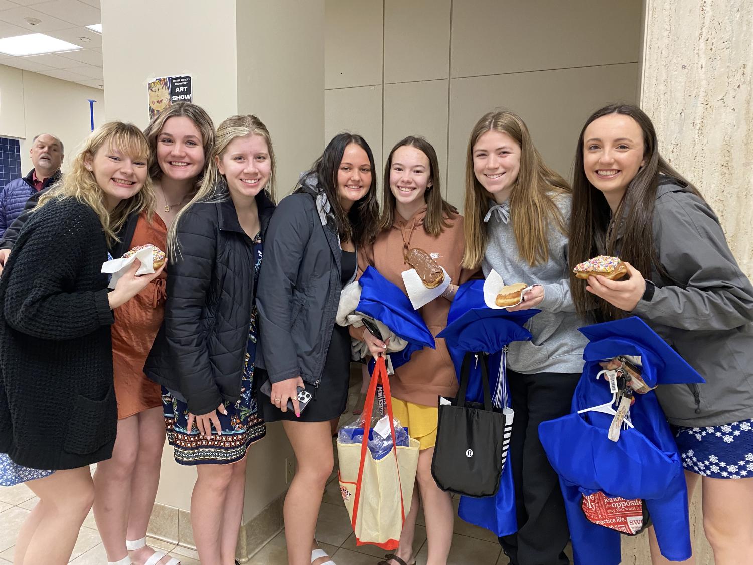 The seniors enjoying their donuts. Including Madison Rymarklwitz, Olivia Blumers, Lexi Danielson, Andie Teske, Megan Costello, Olivia Gardner, and Megan Morgan. 