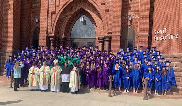 The class of 2022 seniors from the Diocese of Winona-Rochester gather on a cold April day outside of St. Augustines in Austin