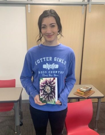 Grace Menke with her copy of Satori, in which her poem Meeting Her is published