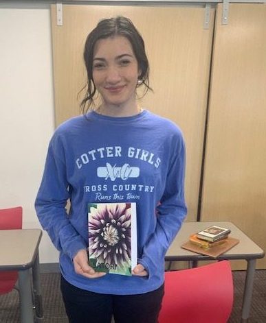 Grace Menke with her copy of Satori, in which her poem "Meeting Her" is published