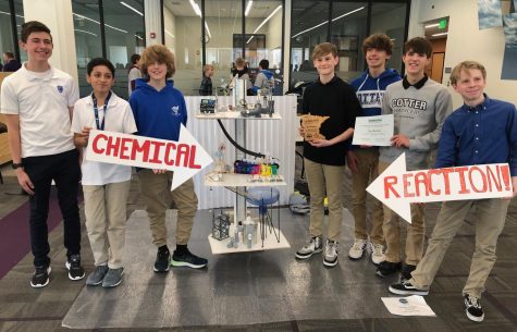 8th graders pose with their Rube Goldberg project (l. to r. Carter Knuesel, Shawn Freyre, Jacob Moore, Zephyr Paulsen, Jack Slaggie, Jaxson Greshik, and William Kirk)