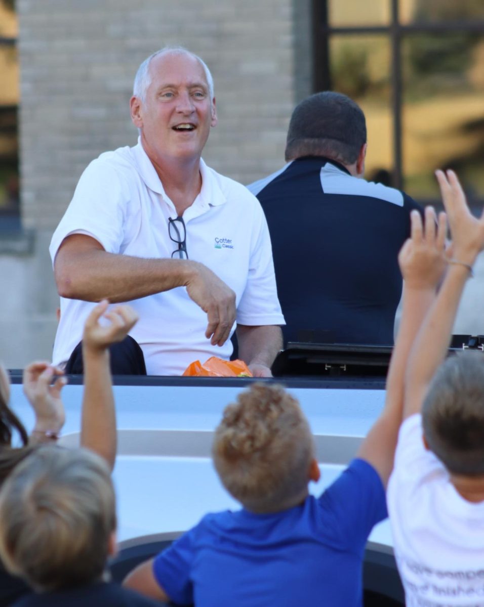 Cotter Principal Dave Forney throws candy at the Homecoming Parade in 2024