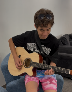 Diego Ayala playing his guitar in the dorm on May 24. 