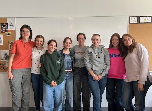 Students from Luxembourg gather in a Cotter classroom during their visit to Winona