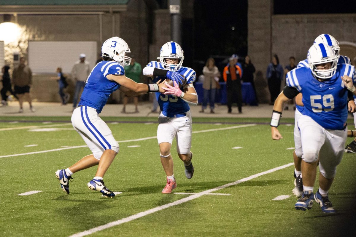 Cade Cummings gets the ball from the quarterback Dane Guzzo and takes off on a big gain at home vs. La Crescent