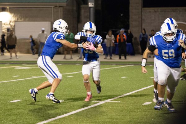 Cade Cummings gets the ball from the quarterback Dane Guzzo and takes off on a big gain at home vs. La Crescent