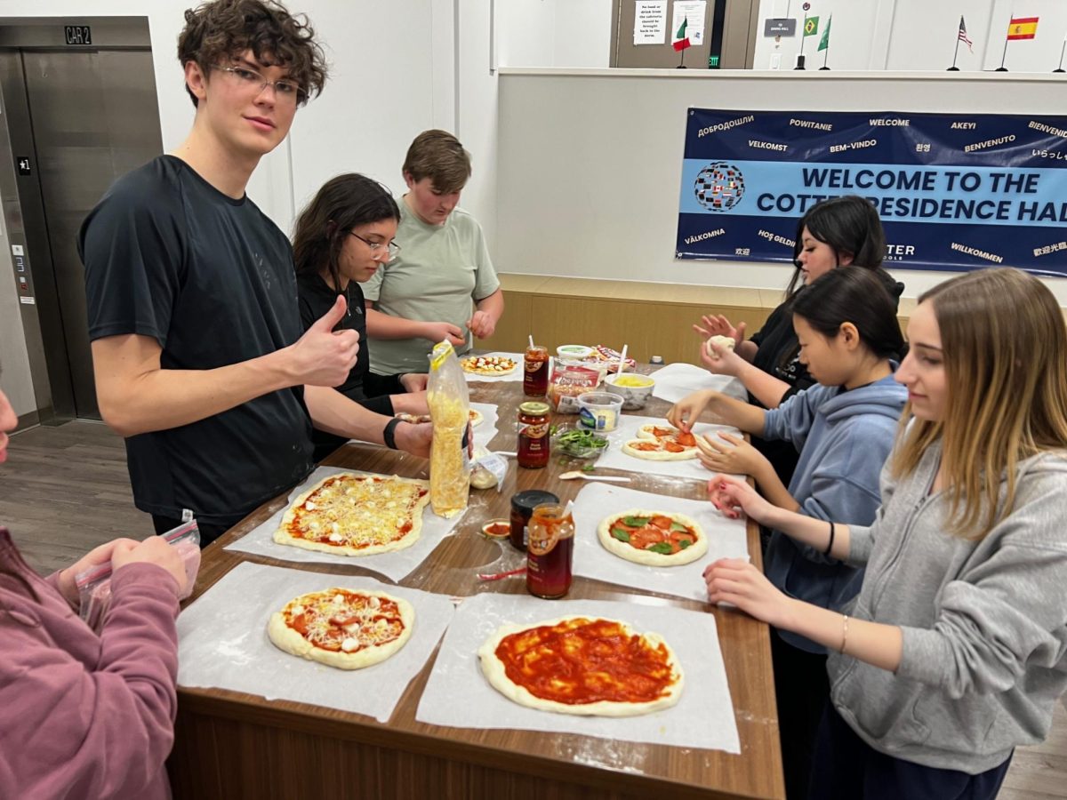 Students at the dorm making pizza together
